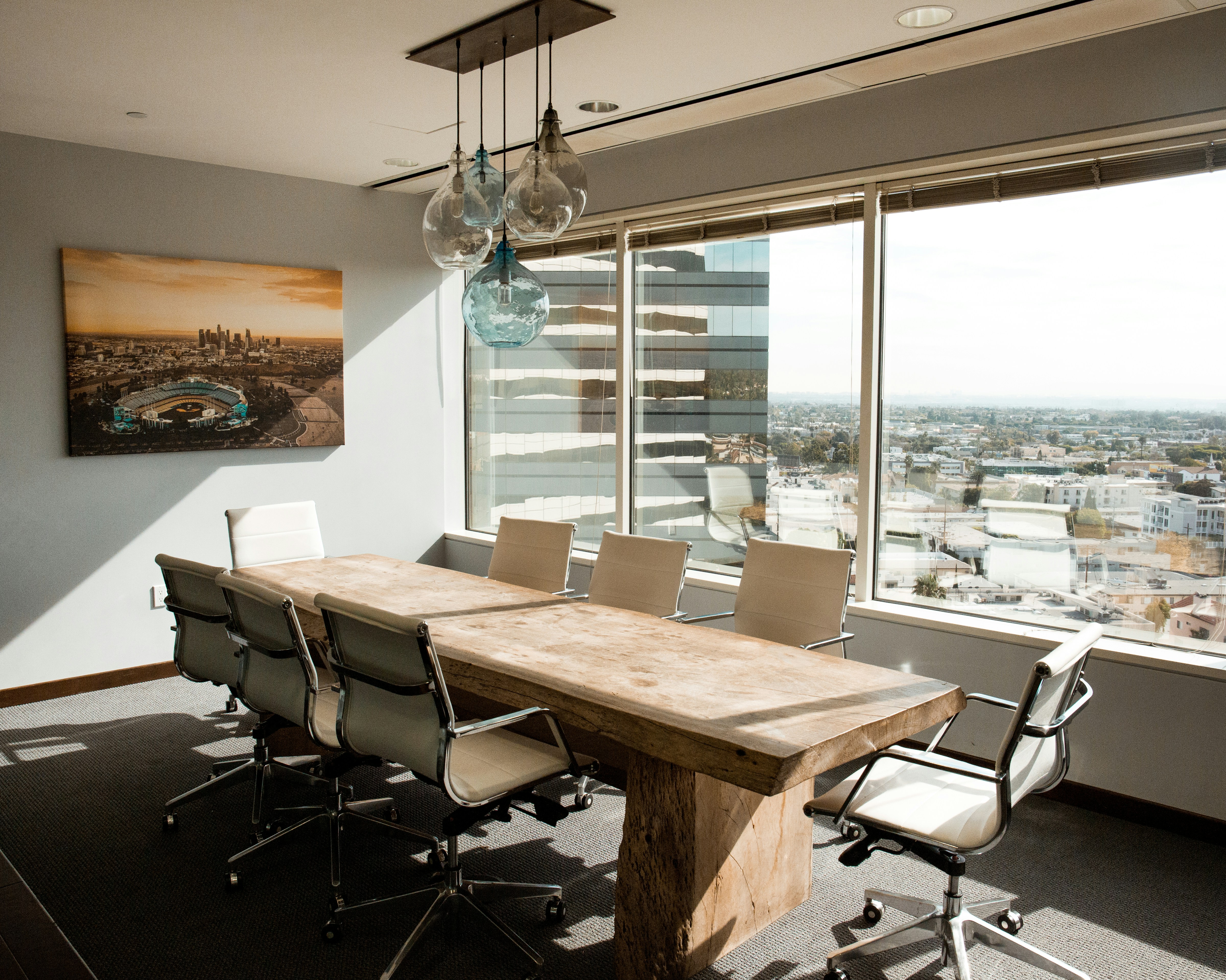 Executive conference room with wood table and white office chairs