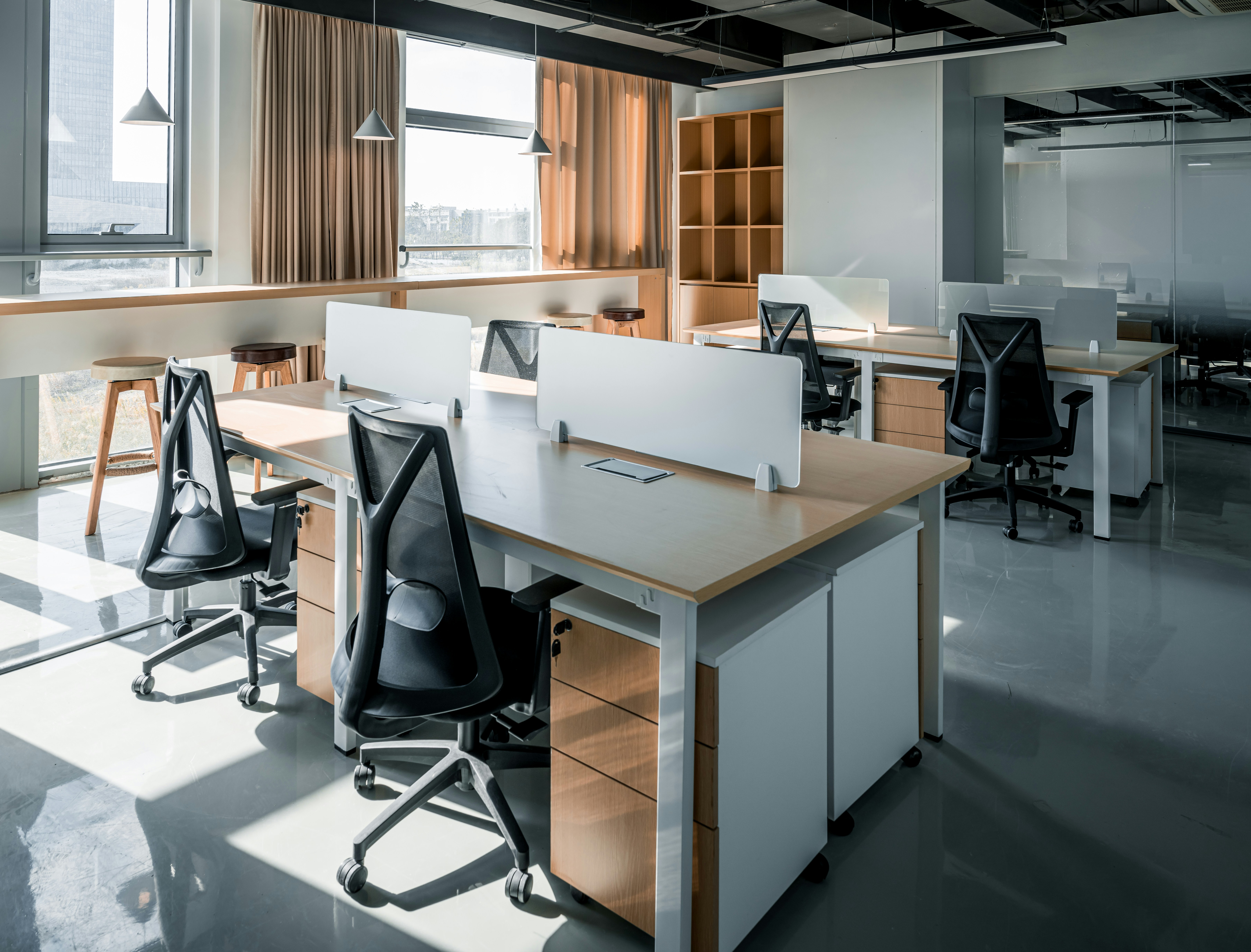 Modern modular office workstations with chairs, desks, and integrated storage